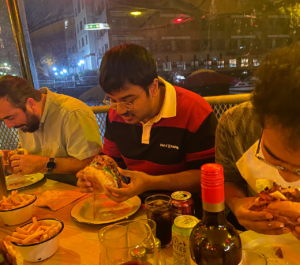3 adult men feasting on burgers in a fast food diner